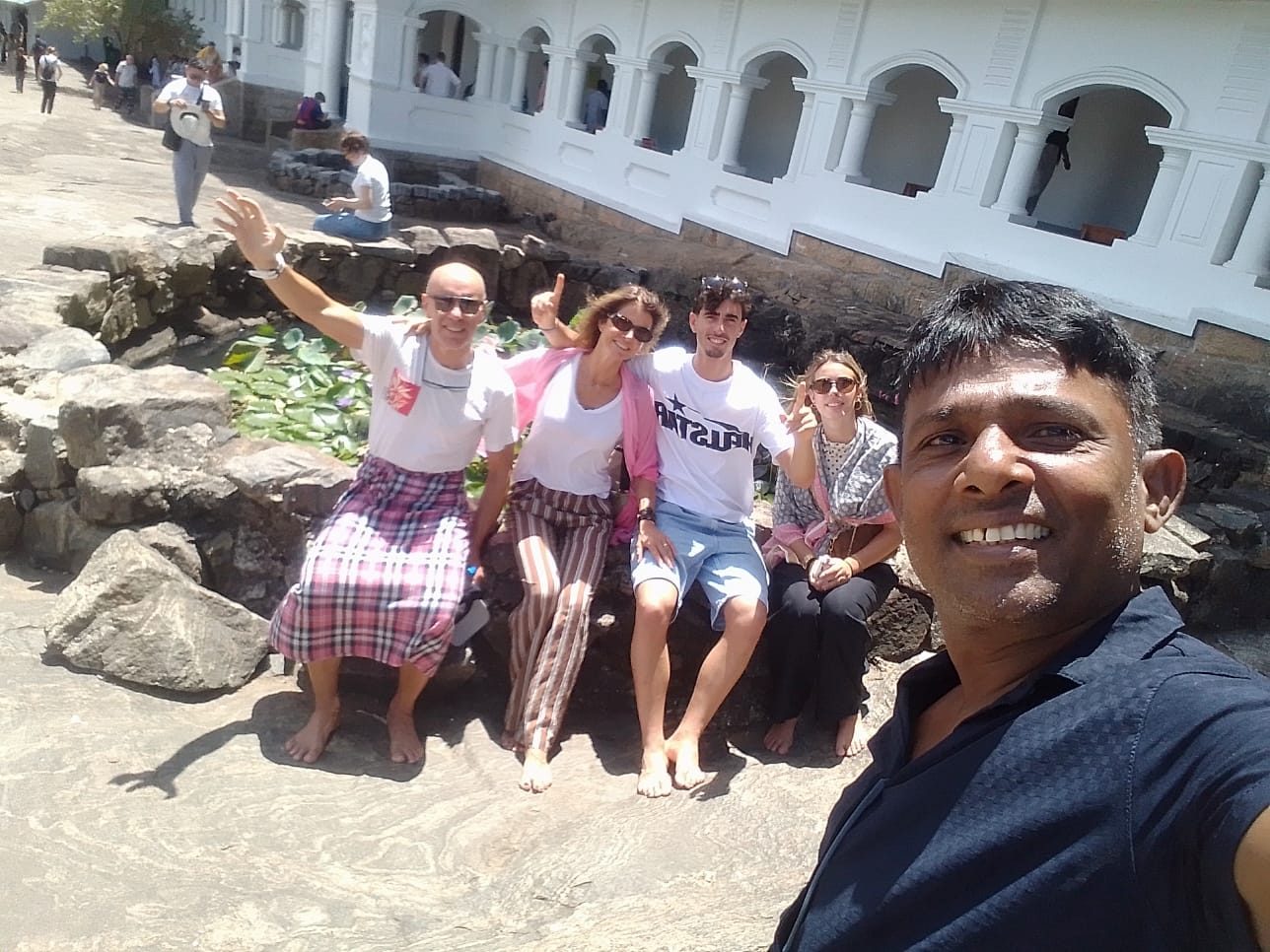 Guests relaxing by the lily pond at Dambulla Cave Temple