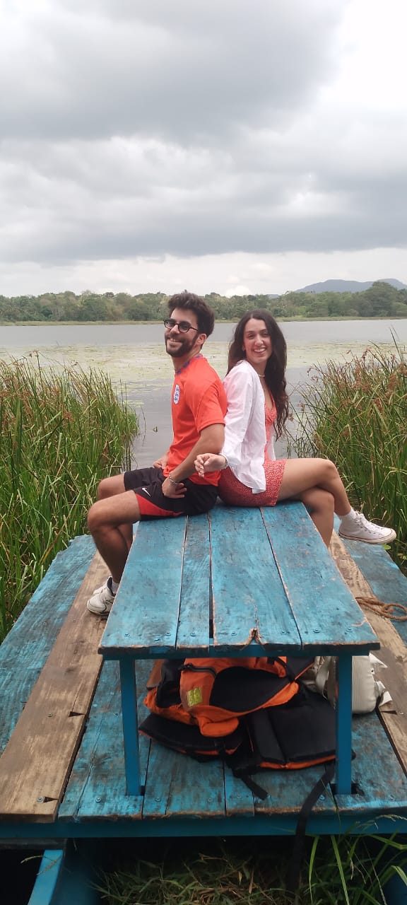 Couple on a wooden lake raft in a village