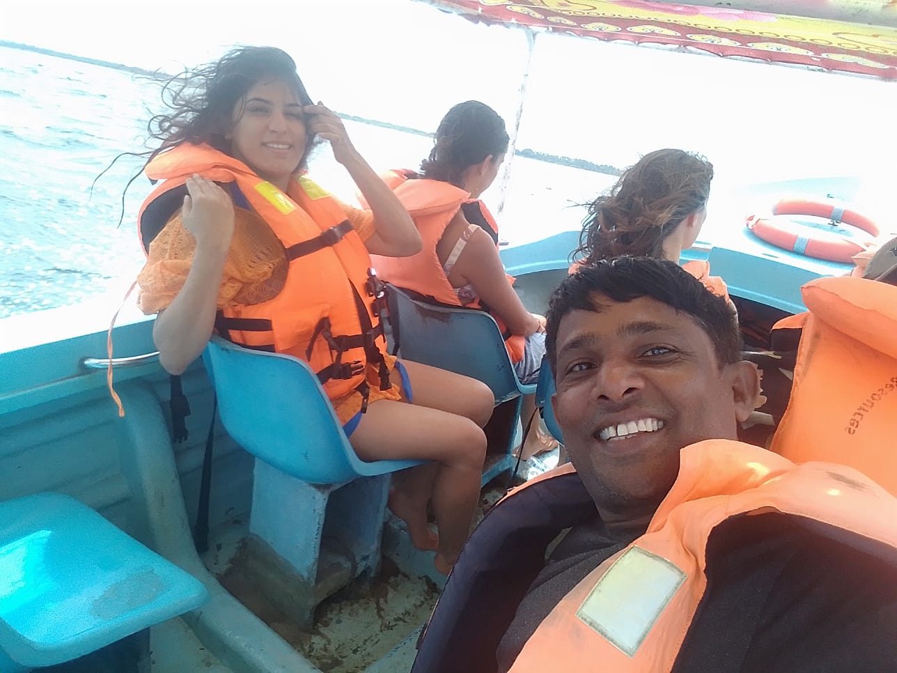 Guests in life jackets on a boat ride