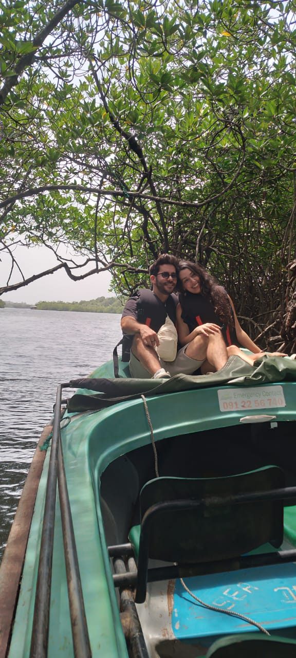 Couple on a boat among the mangroves of the Madu River
