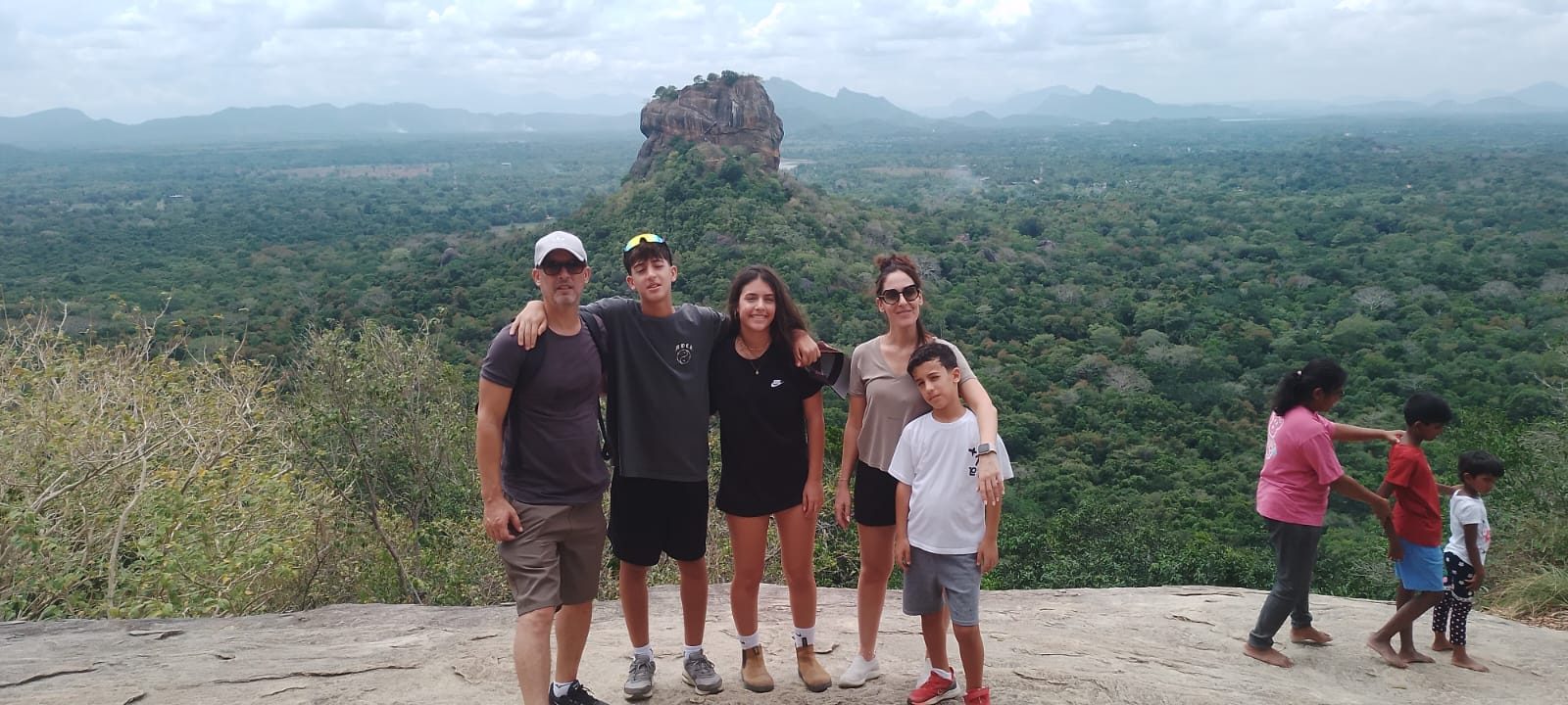Family at the top of Pidurangala with Sigiriya Rock behind